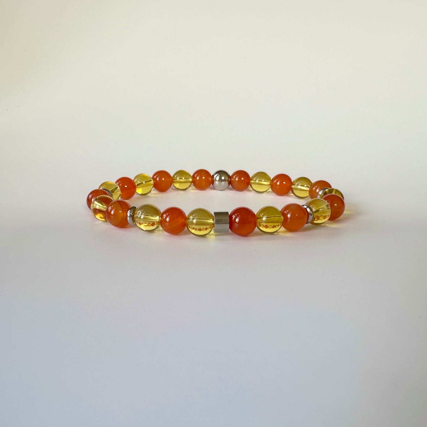 Apollo's Prosperity Bracelet with Citrine and Red Carnelian stones, symbolizing abundance, motivation, and positivity in a stylish design.