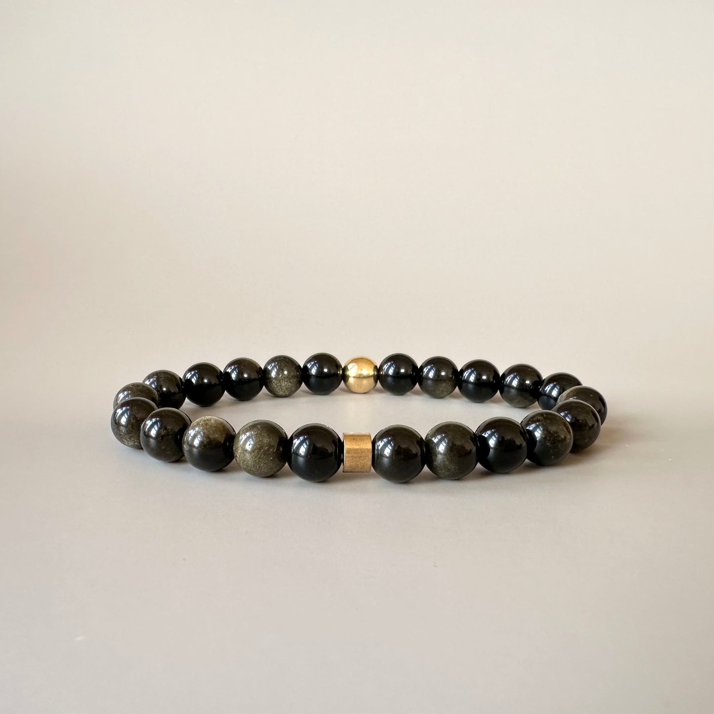Natural Gold Obsidian Bracelets for Couples displayed, with gold obsidian stones shining and symbolizing wisdom and protection.
