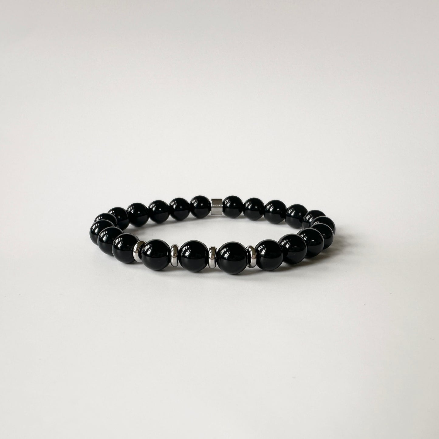 Close-up of Natural Black Onyx Bracelets for couples, featuring a sleek silver design for timeless elegance.