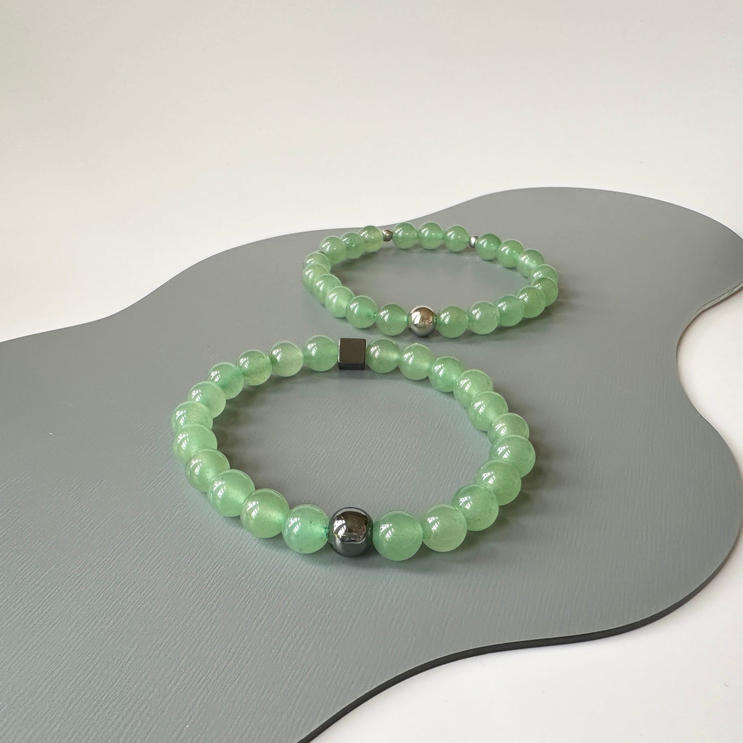 Natural Green Aventurine Bracelets for couples, symbolizing opportunity and renewal, displayed on a clean surface.