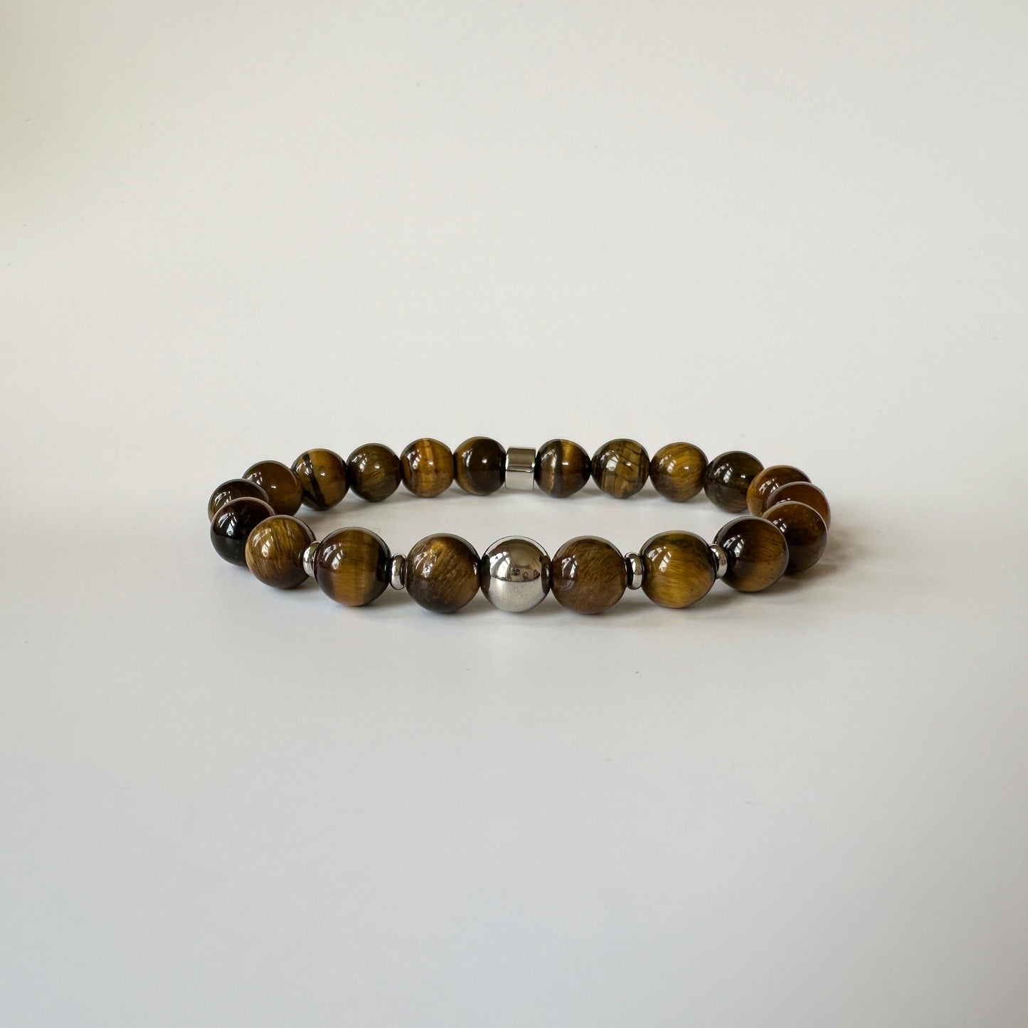 Close-up of polished tiger eye beads on the Natural Tiger Eye Bracelet for Her, highlighting its unique golden and brown patterns.