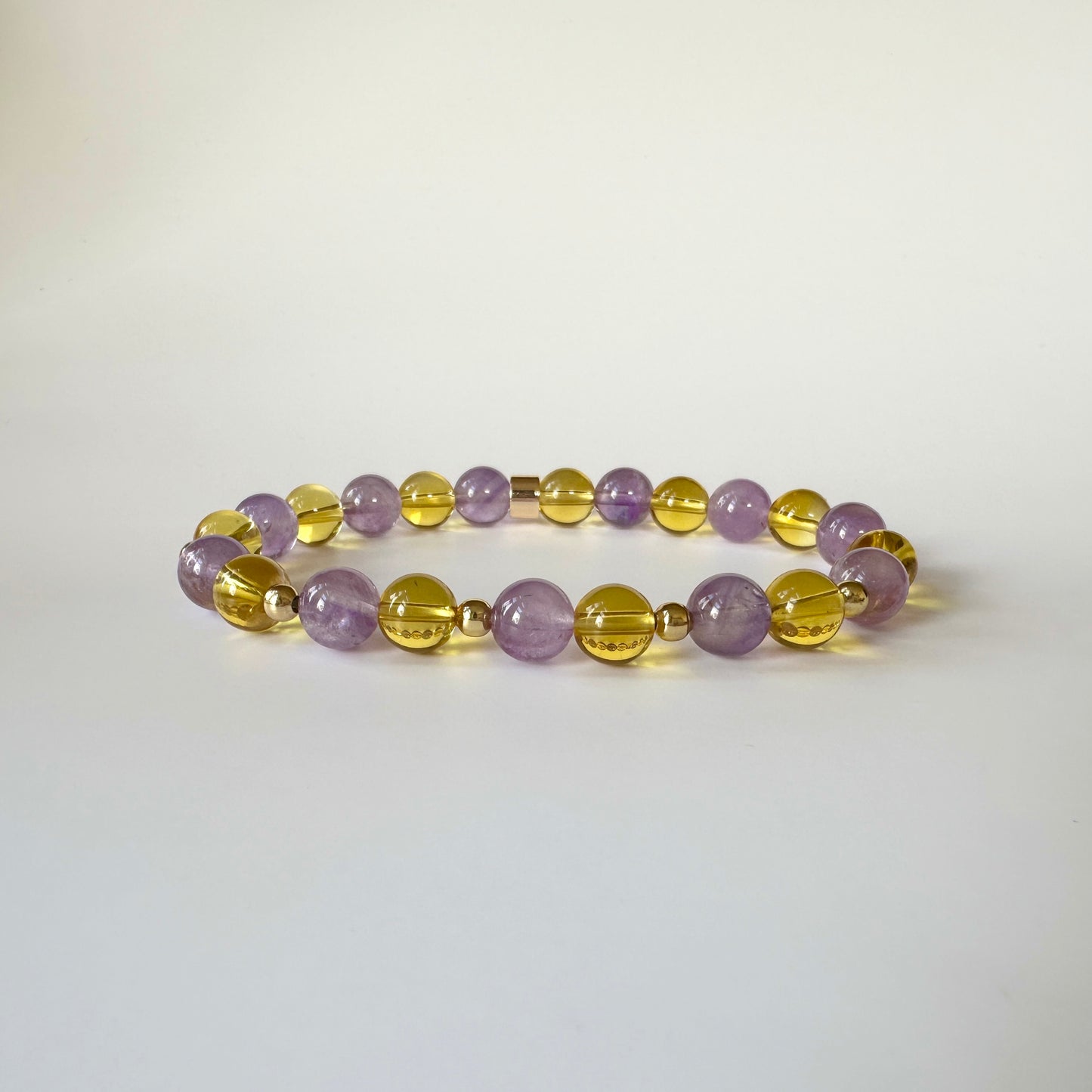 Aurora’s Radiance Bracelet with lavender amethyst and citrine gemstones, promoting tranquility, spiritual growth, positivity, and abundance.