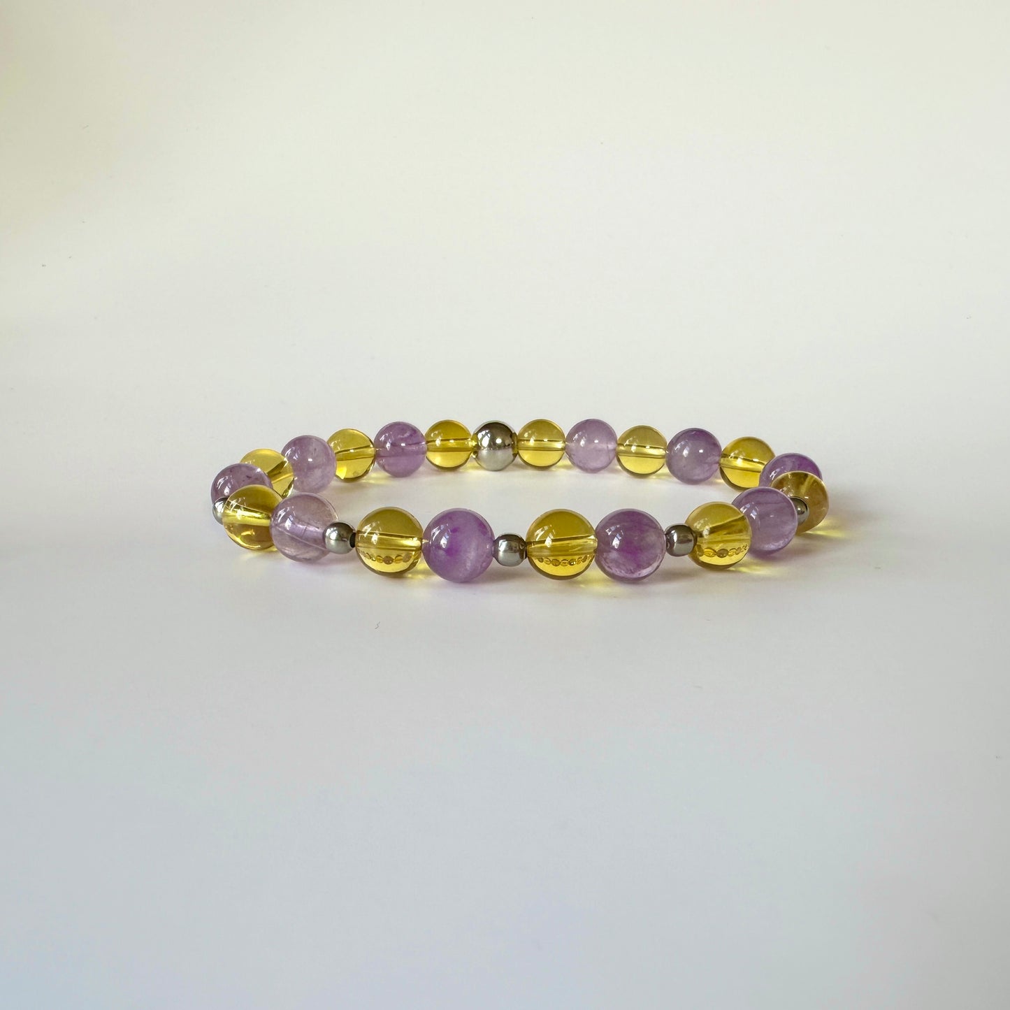 Aurora’s Radiance Bracelet with lavender amethyst and citrine gemstones, promoting tranquility, spiritual growth, positivity, and abundance.