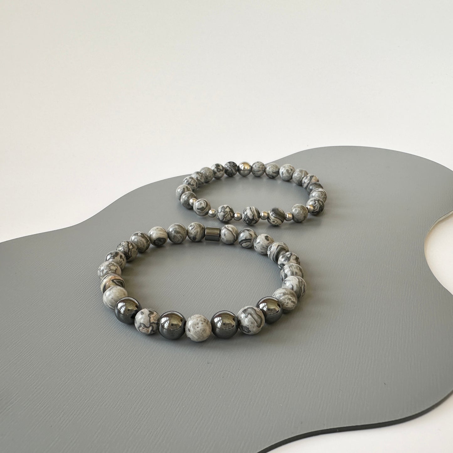 Close-up of polished grey jasper beads on the Natural Grey Jasper Bracelets for Couples, showcasing their earthy tones and smooth texture.