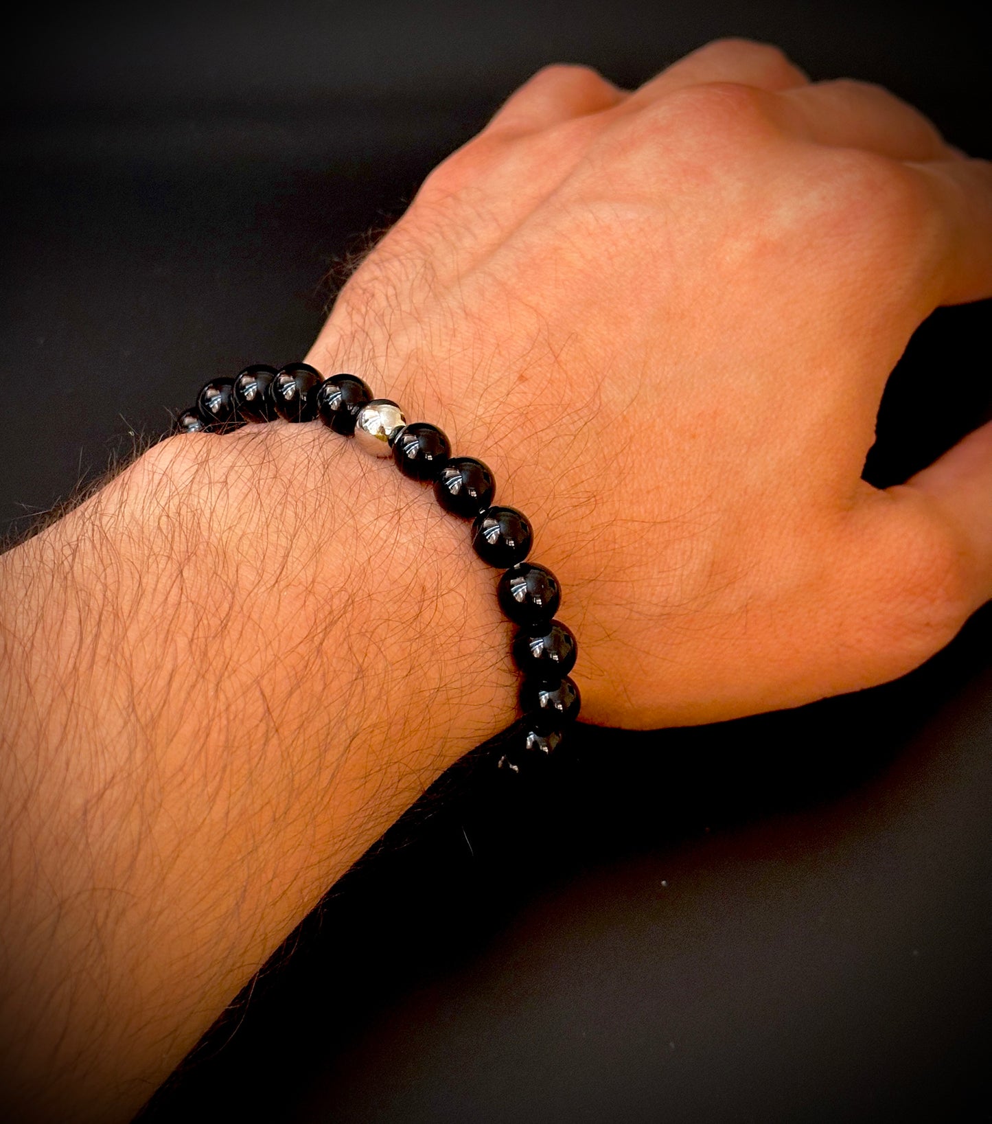 Model wearing the Natural Black Onyx Bracelet for Him, emphasizing its protective and transformative qualities.