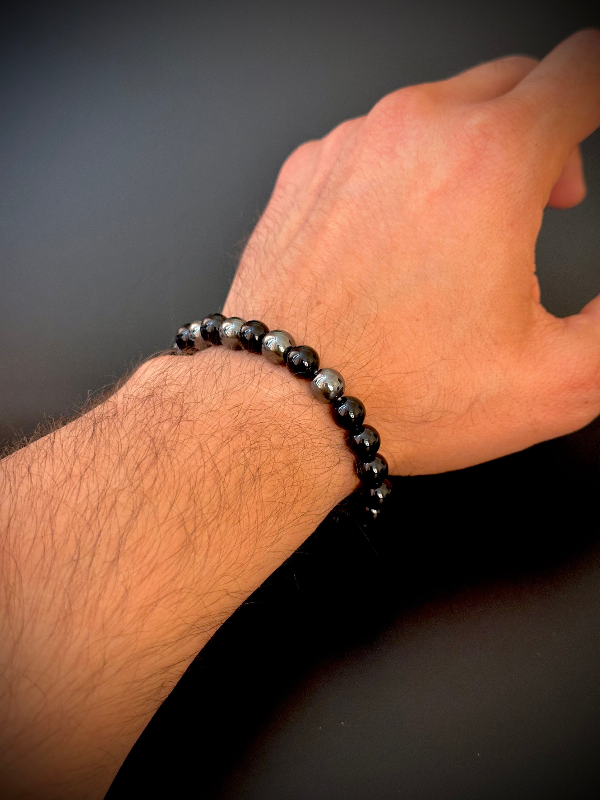 Model wearing the Natural Black Onyx Bracelet for Him, emphasizing its protective and transformative qualities.