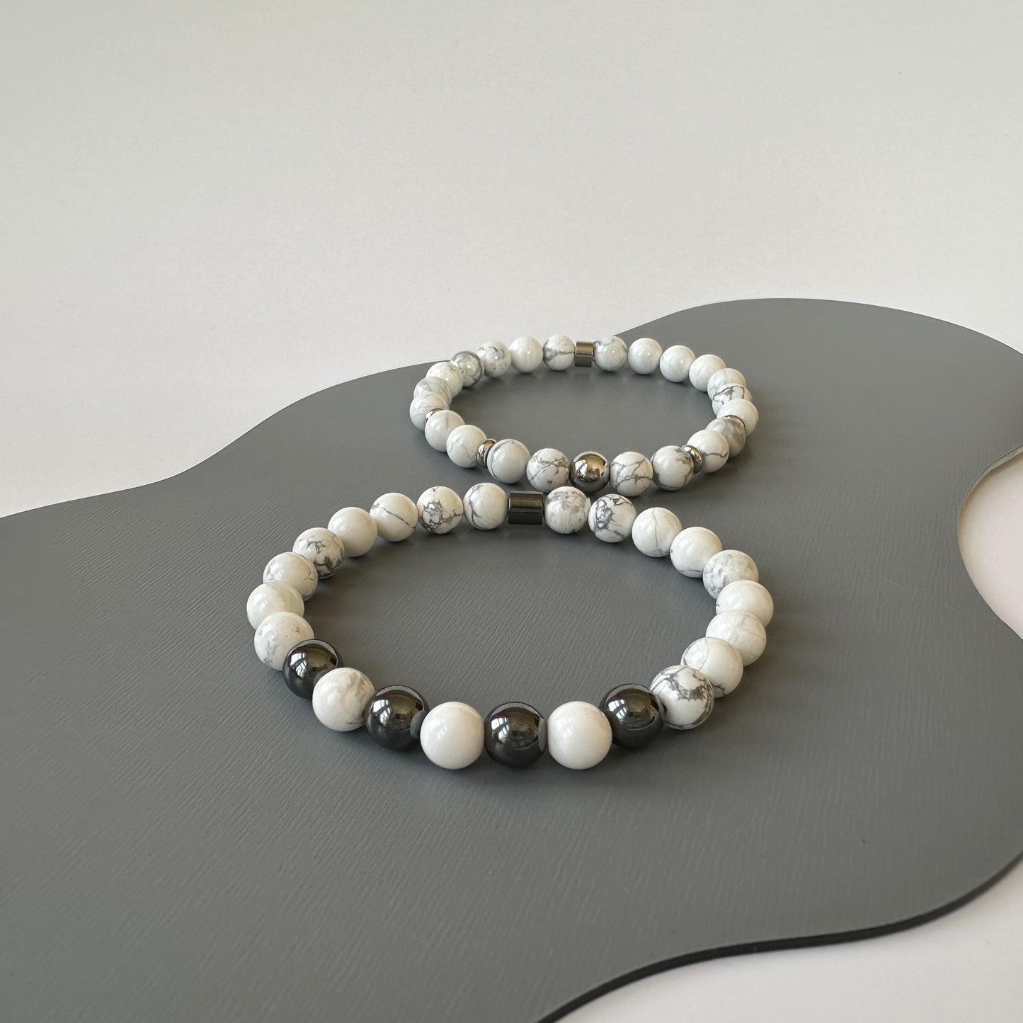 Natural Howlite Bracelets for couples, symbolizing calm and clarity, displayed elegantly on a neutral surface.