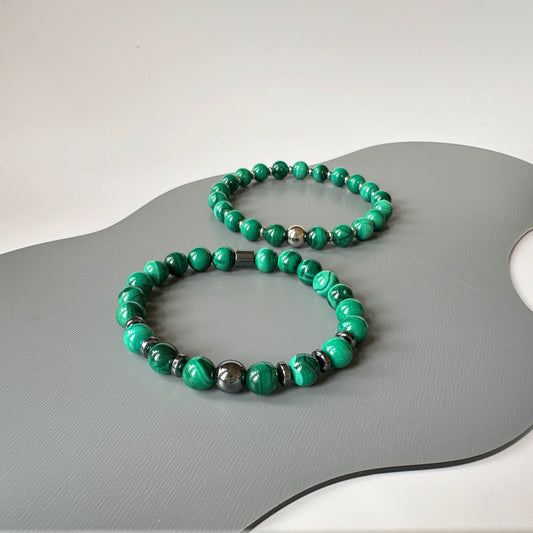 A pair of Natural Malachite Bracelets symbolizing love, transformation, and harmony for couples.