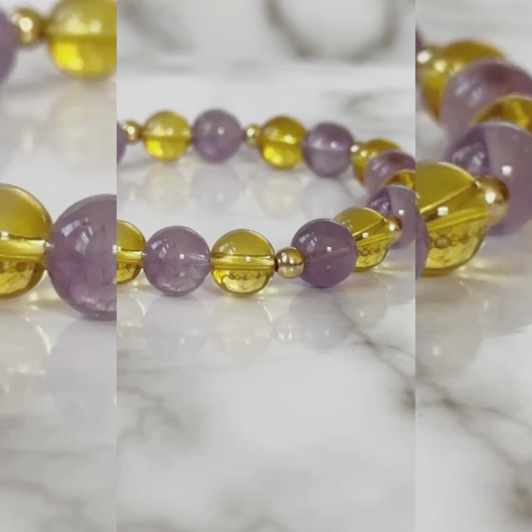 Aurora’s Radiance Bracelet with lavender amethyst and citrine gemstones, promoting tranquility, spiritual growth, positivity, and abundance.