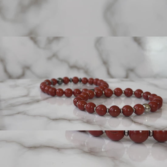 Close-up of polished red jasper beads on the Natural Red Jasper Bracelets for Couples, showcasing their rich red color and smooth finish.