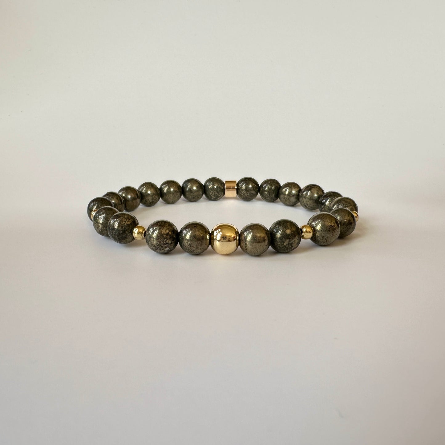 Close-up of polished pyrite beads on the Natural Pyrite Bracelets for Couples, highlighting their golden sheen and smooth finish.