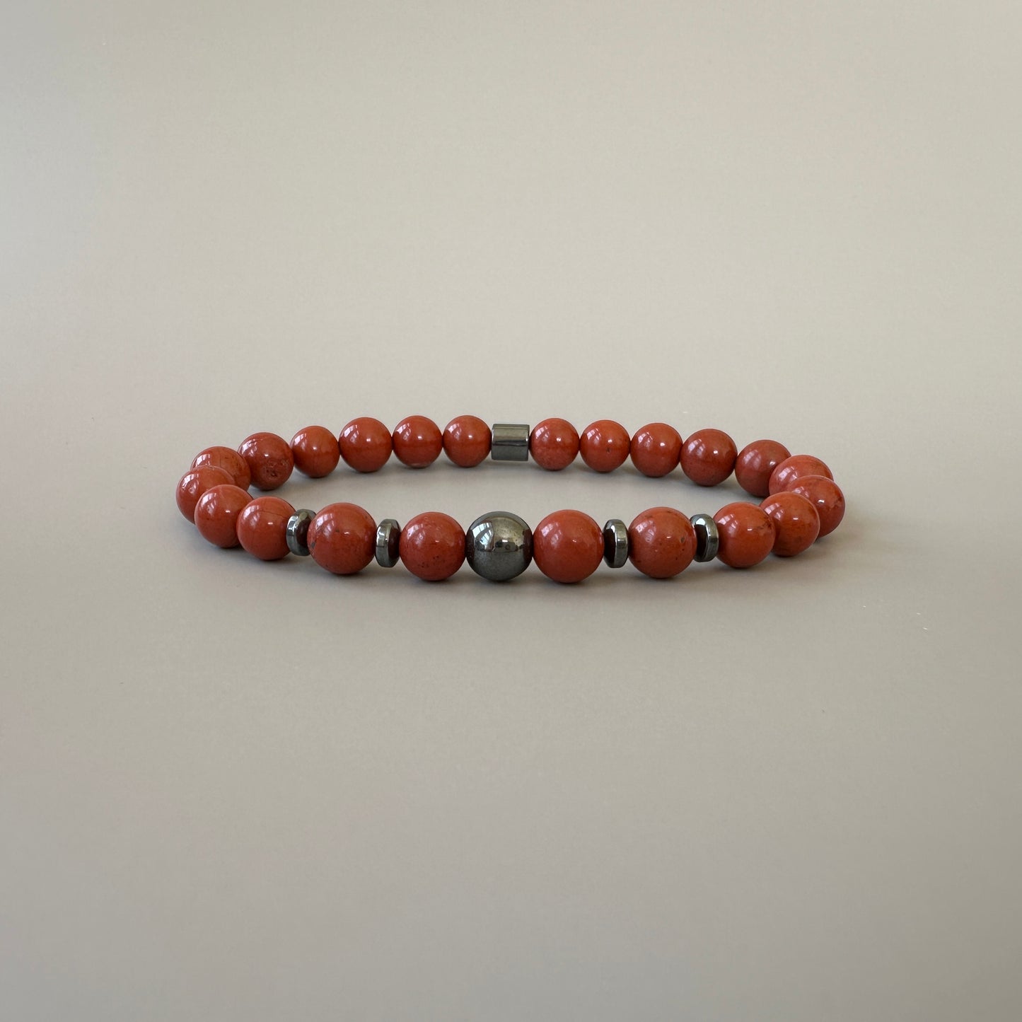 Close-up of polished red jasper beads on the Natural Red Jasper Bracelets for Couples, showcasing their rich red color and smooth finish.